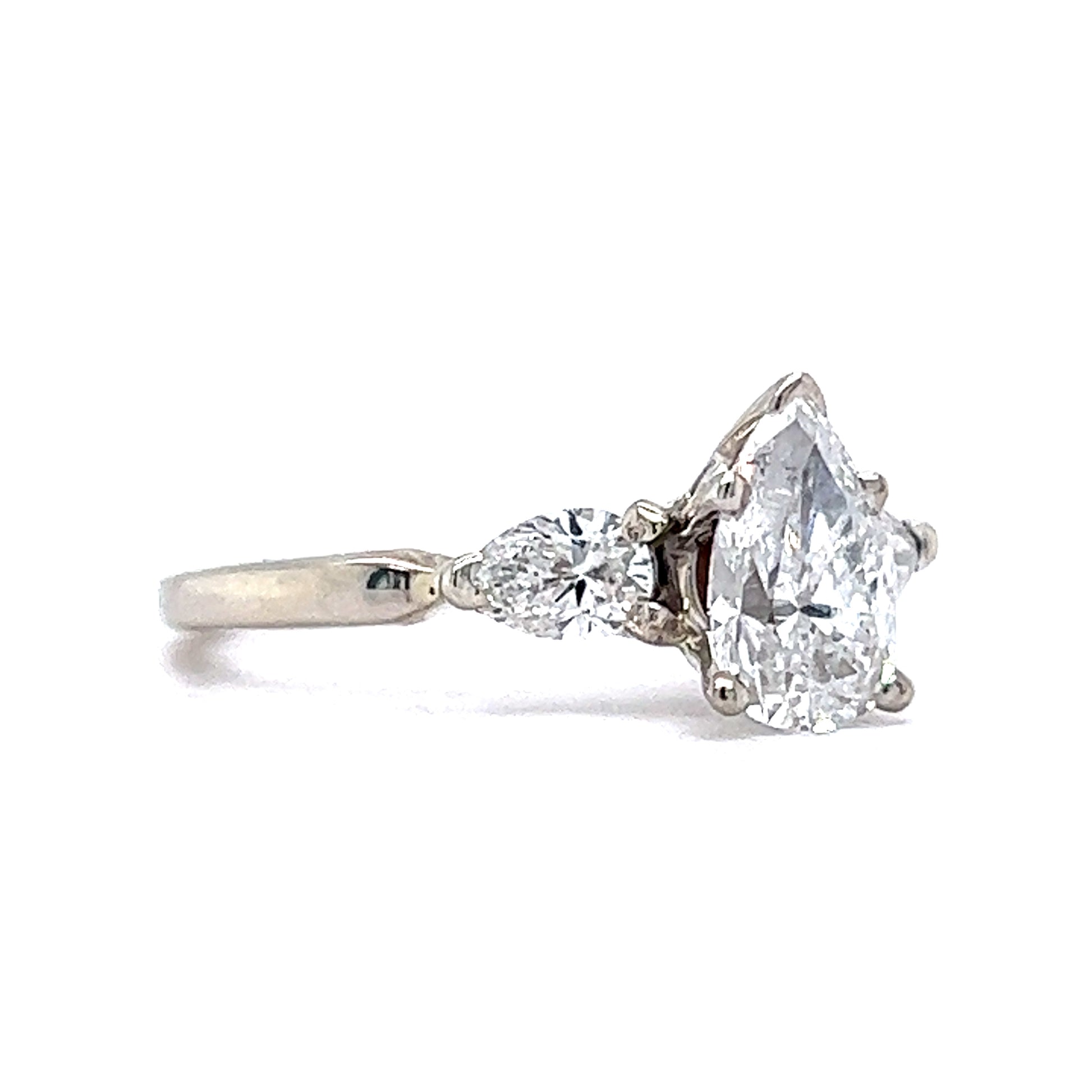 .96 White Gold Three Stone Pear Diamond RingComposition: 14 Karat White Gold Ring Size: 6.0 Total Diamond Weight: 1.46ct Total Gram Weight: 2.6 g Inscription: 14k
      