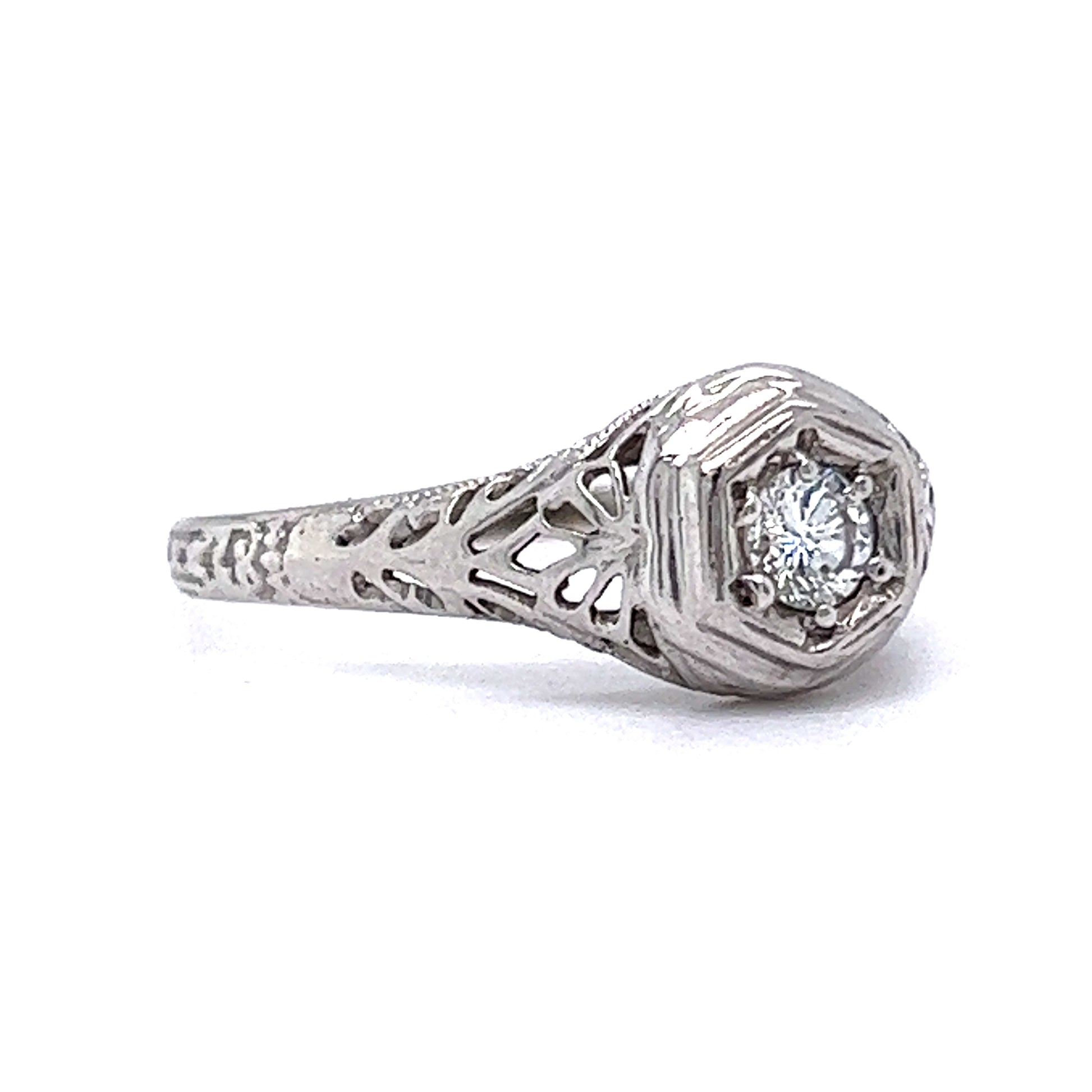 .19 Vintage Art Deco Diamond Engagement Ring in 18k White GoldComposition: 18 Karat White Gold Ring Size: 6.5 Total Diamond Weight: .19ct Total Gram Weight: 1.63 g Inscription: 18k
      