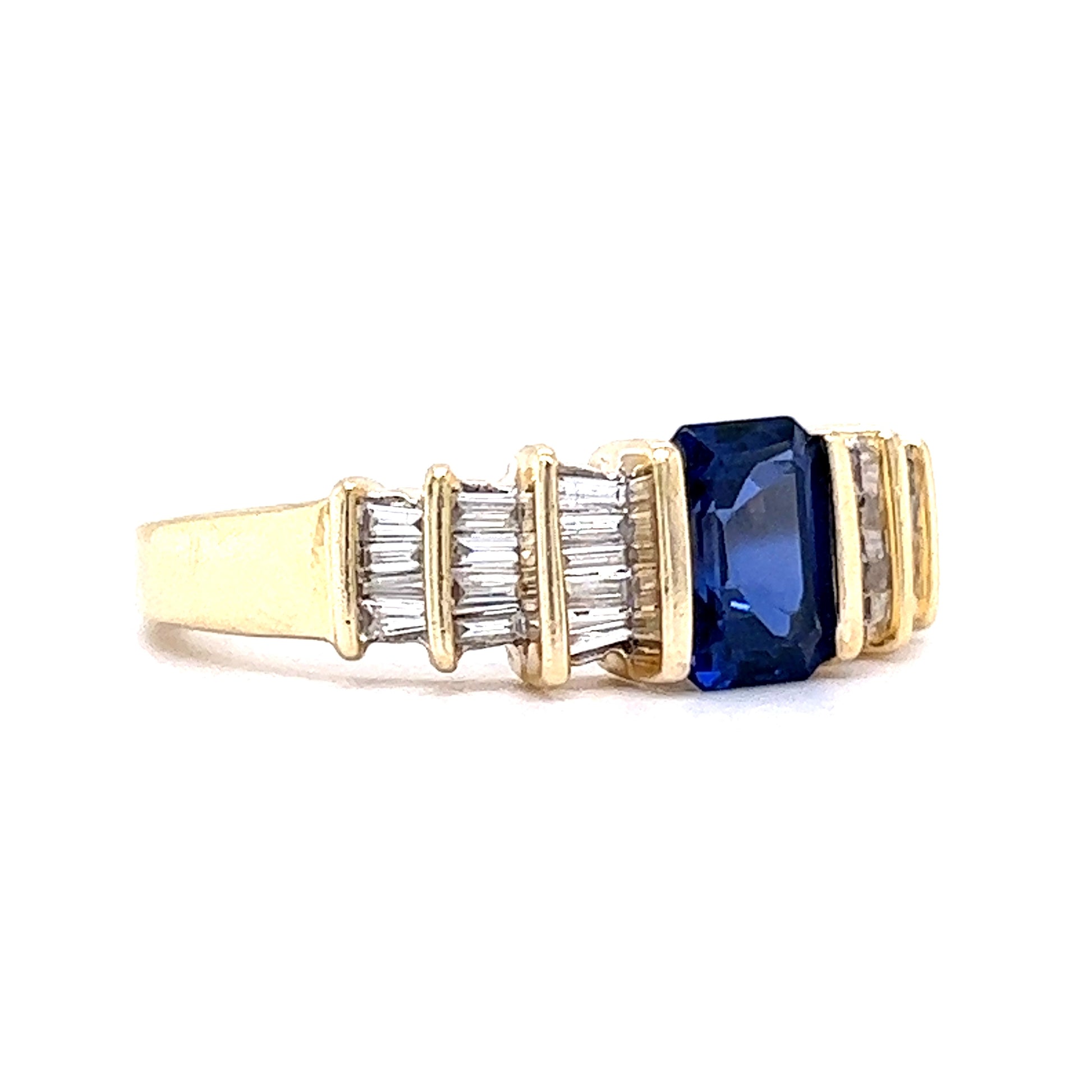 1.30 Emerald Cut Tanzanite Engagement Ring in 14k Yellow GoldComposition: 14 Karat Yellow GoldRing Size: 9.0Total Diamond Weight: .78 ctTotal Gram Weight: 4.0 gInscription: 14k