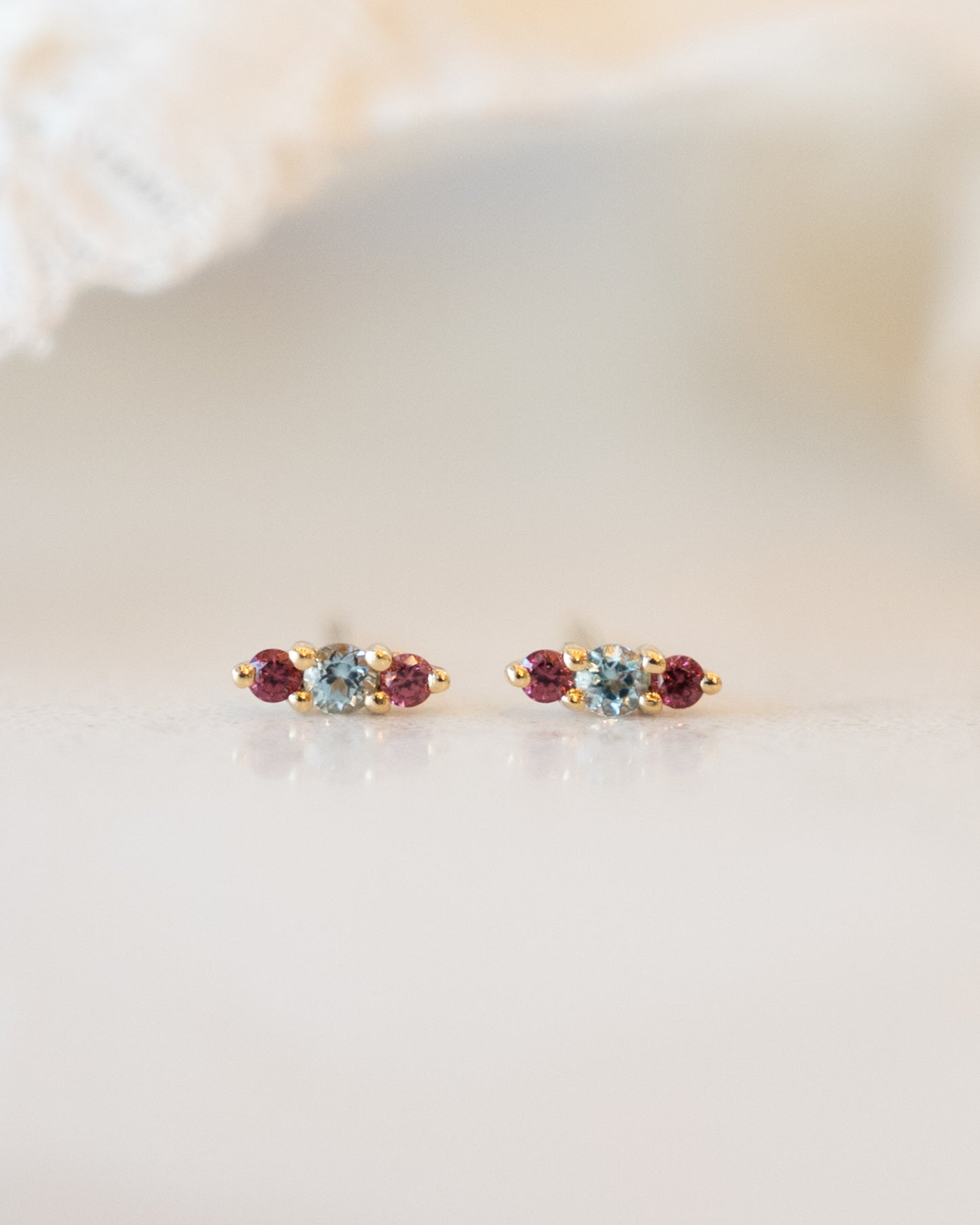 Blue Topaz & Garnet Stud Earrings in 14k Yellow Gold