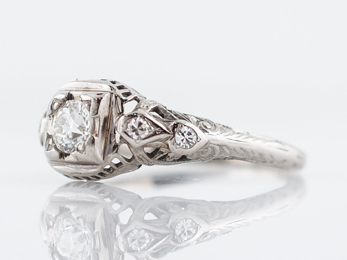 Antique Engagement Ring Art Deco .31 Transitional Cut Diamond in 18k White GoldComposition: Platinum Total Diamond Weight: .39ct Total Gram Weight: 2.50 g