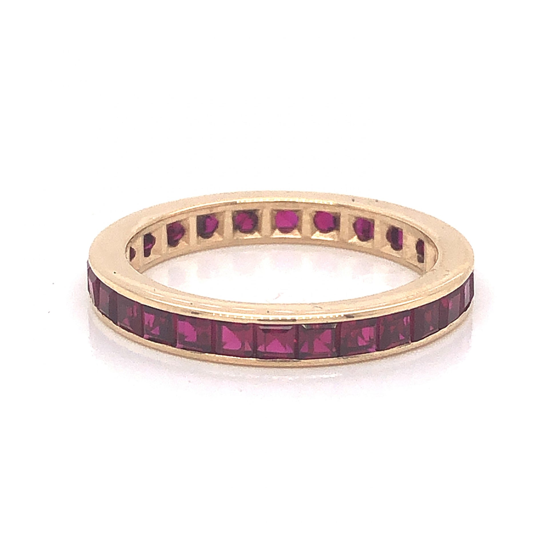 Channel Set Ruby Eternity Wedding Band in 14k Yellow GoldComposition: 14 Karat Yellow Gold Ring Size: 6 Total Gram Weight: 1.9 g
