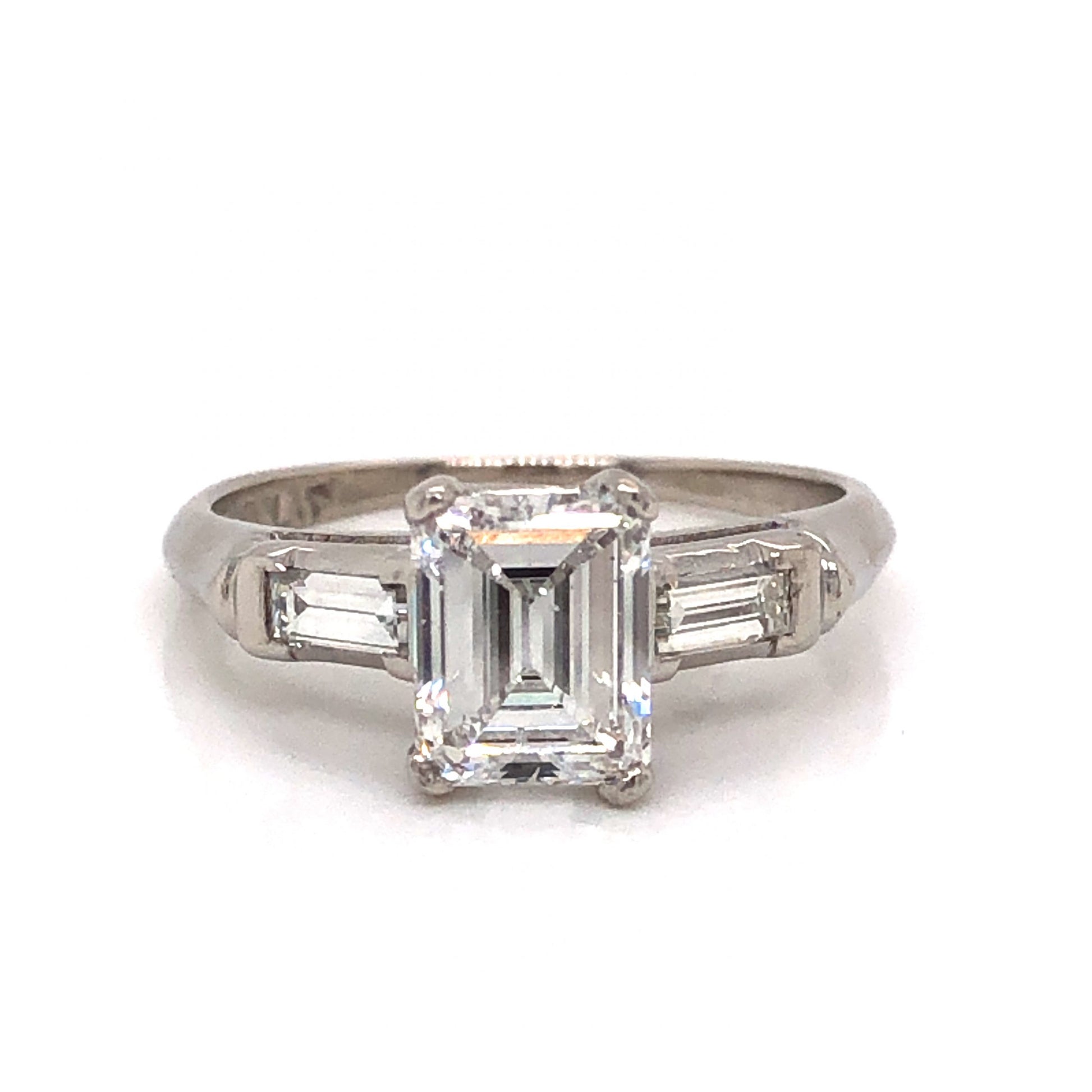 .97 Emerald Cut Art Deco Diamond Engagement Ring in PlatinumComposition: PlatinumRing Size: 4.5Total Diamond Weight: 1.27 ctTotal Gram Weight: 3.5 gInscription: 10% IRID PLAT