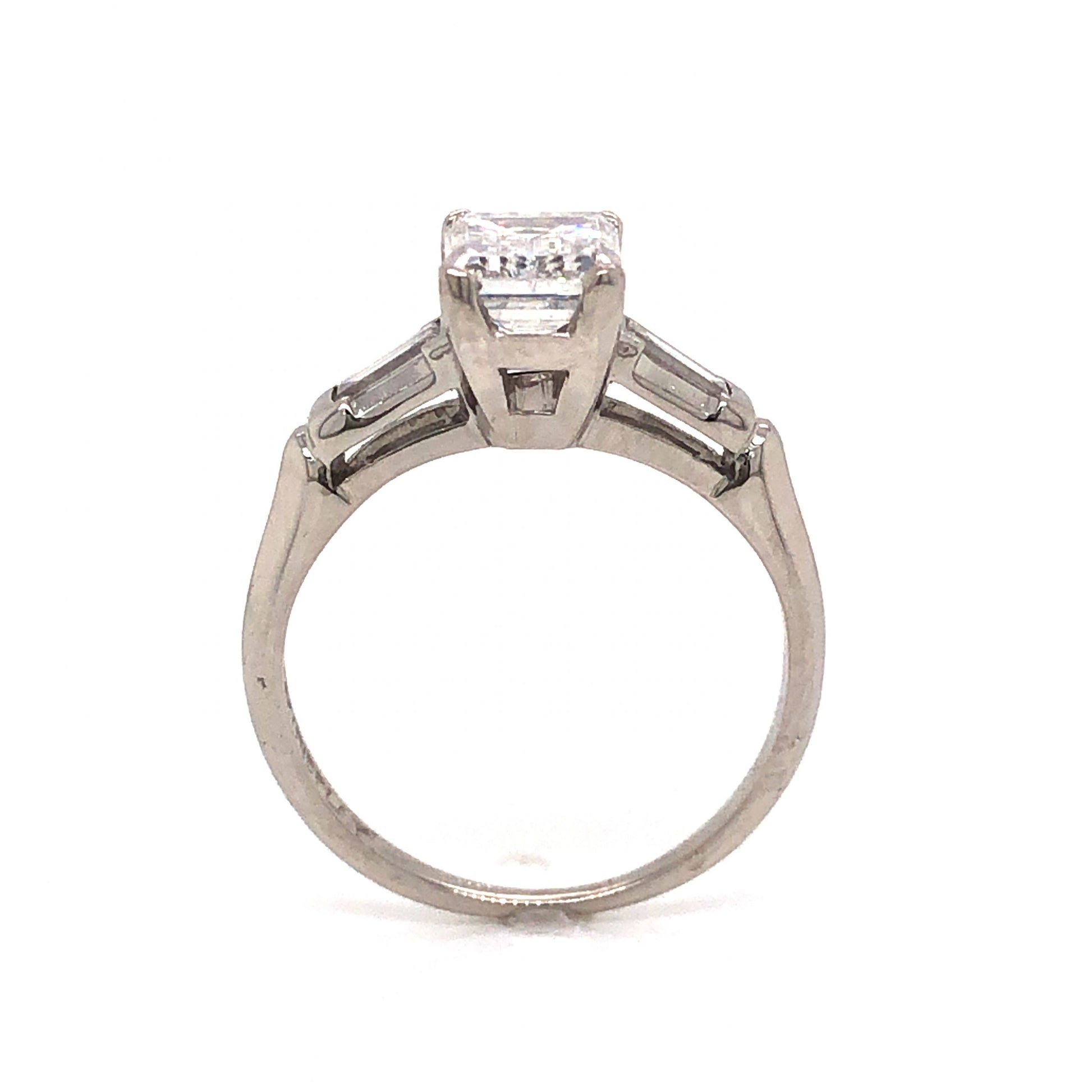 .97 Emerald Cut Art Deco Diamond Engagement Ring in PlatinumComposition: PlatinumRing Size: 4.5Total Diamond Weight: 1.27 ctTotal Gram Weight: 3.5 gInscription: 10% IRID PLAT