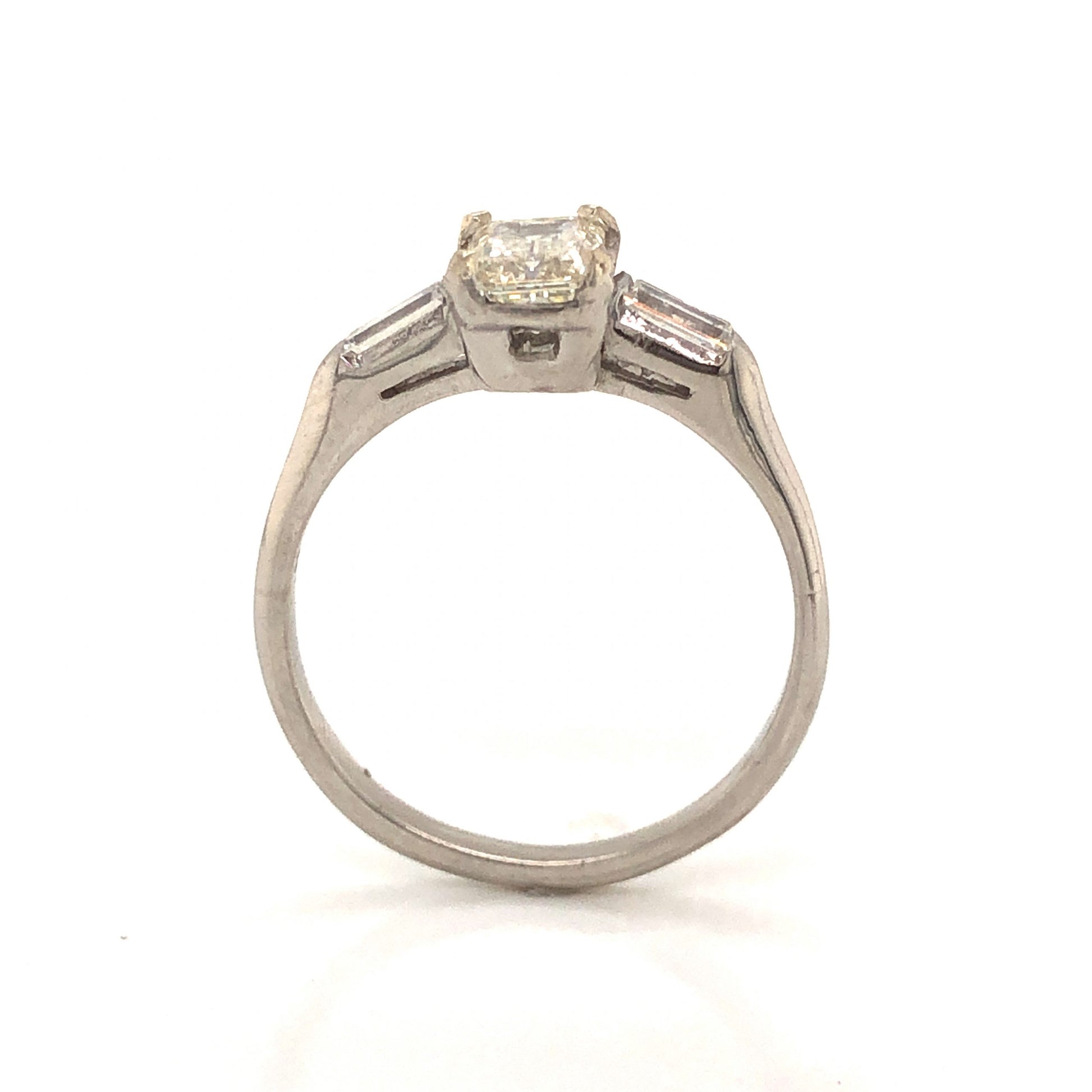 Vintage .63 Emerald Cut Diamond Engagement Ring in PlatinumComposition: PlatinumRing Size: 5.5Total Diamond Weight: .93 ctTotal Gram Weight: 3.5 gInscription: 90