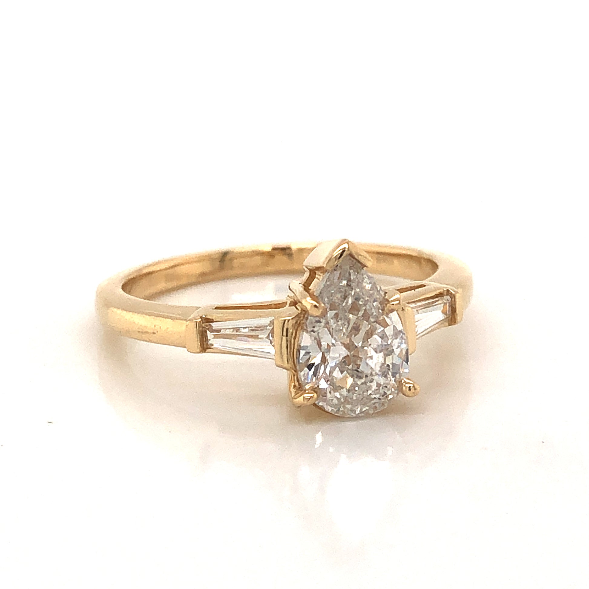 1.01 Pear Cut Diamond Engagement Ring in 14k Yellow GoldComposition: 14 Karat Yellow GoldRing Size: 6.5Total Diamond Weight: 1.23 ctTotal Gram Weight: 3.1 gInscription: 14k 