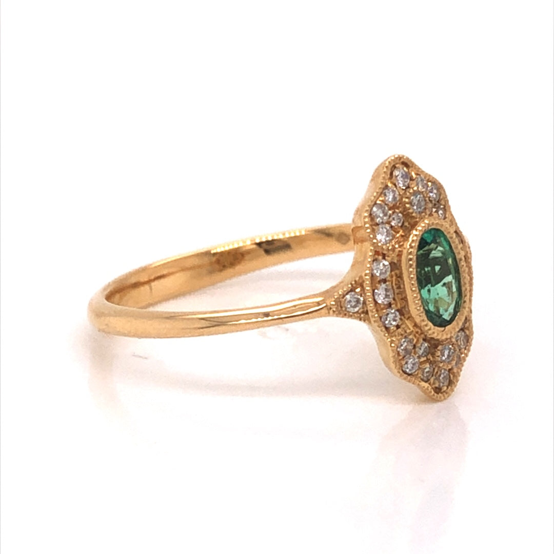 Antique Inspired Oval Emerald & Diamond Ring in 18k Yellow GoldComposition: 18 Karat Yellow GoldRing Size: 6.5Total Diamond Weight: .11 ctTotal Gram Weight: 2.1 gInscription: JHK 18k
