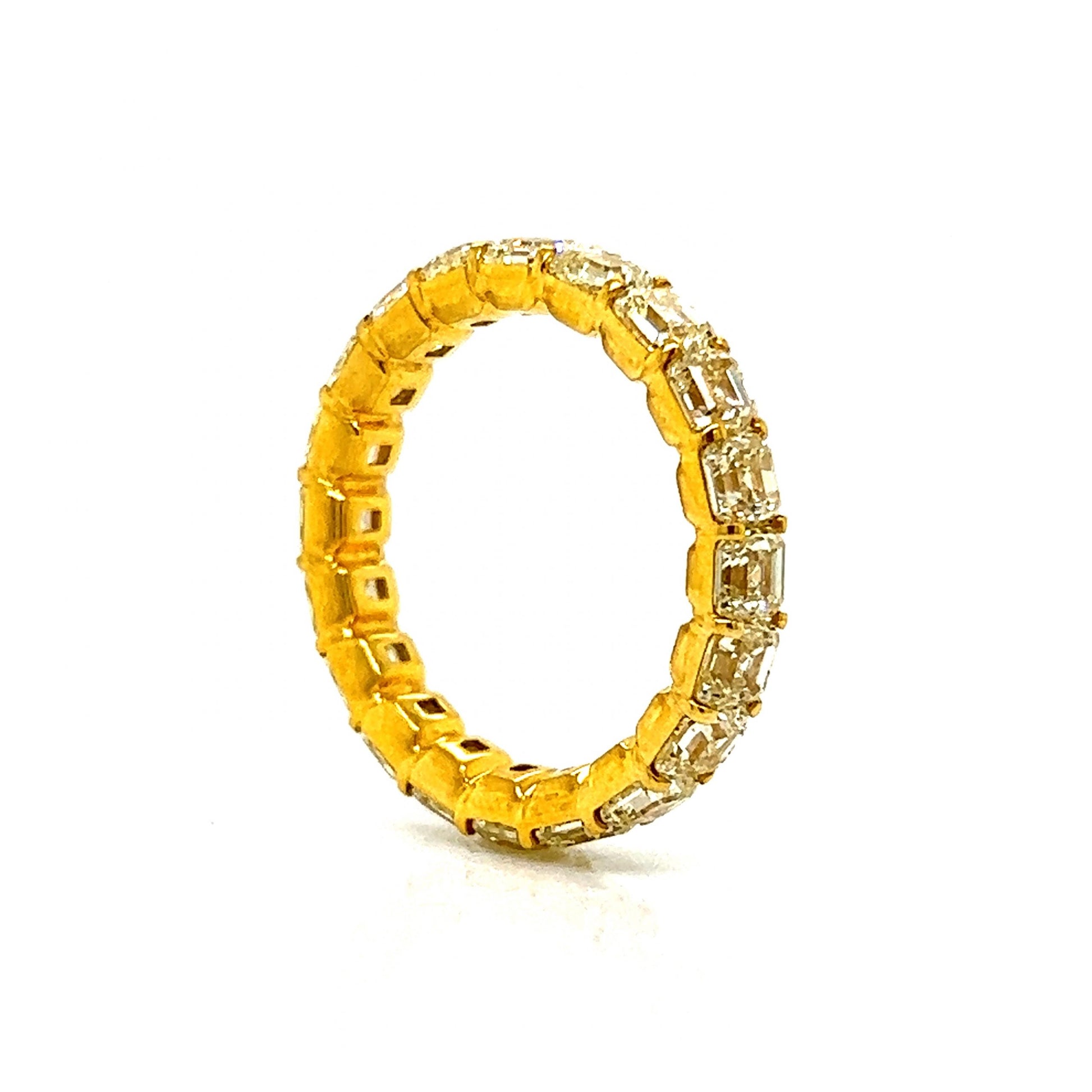 5.58 Fancy Yellow Asscher Cut Diamond Eternity Band in 18kComposition: 18 Karat Yellow Gold Ring Size: 7 Total Diamond Weight: 5.58ct Total Gram Weight: 3.4 g