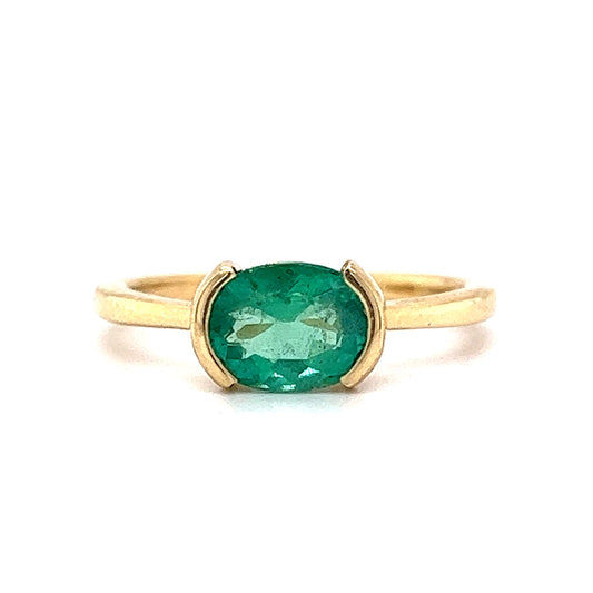 Half Bezel Set Oval Cut Emerald Ring in 14k Yellow Gold