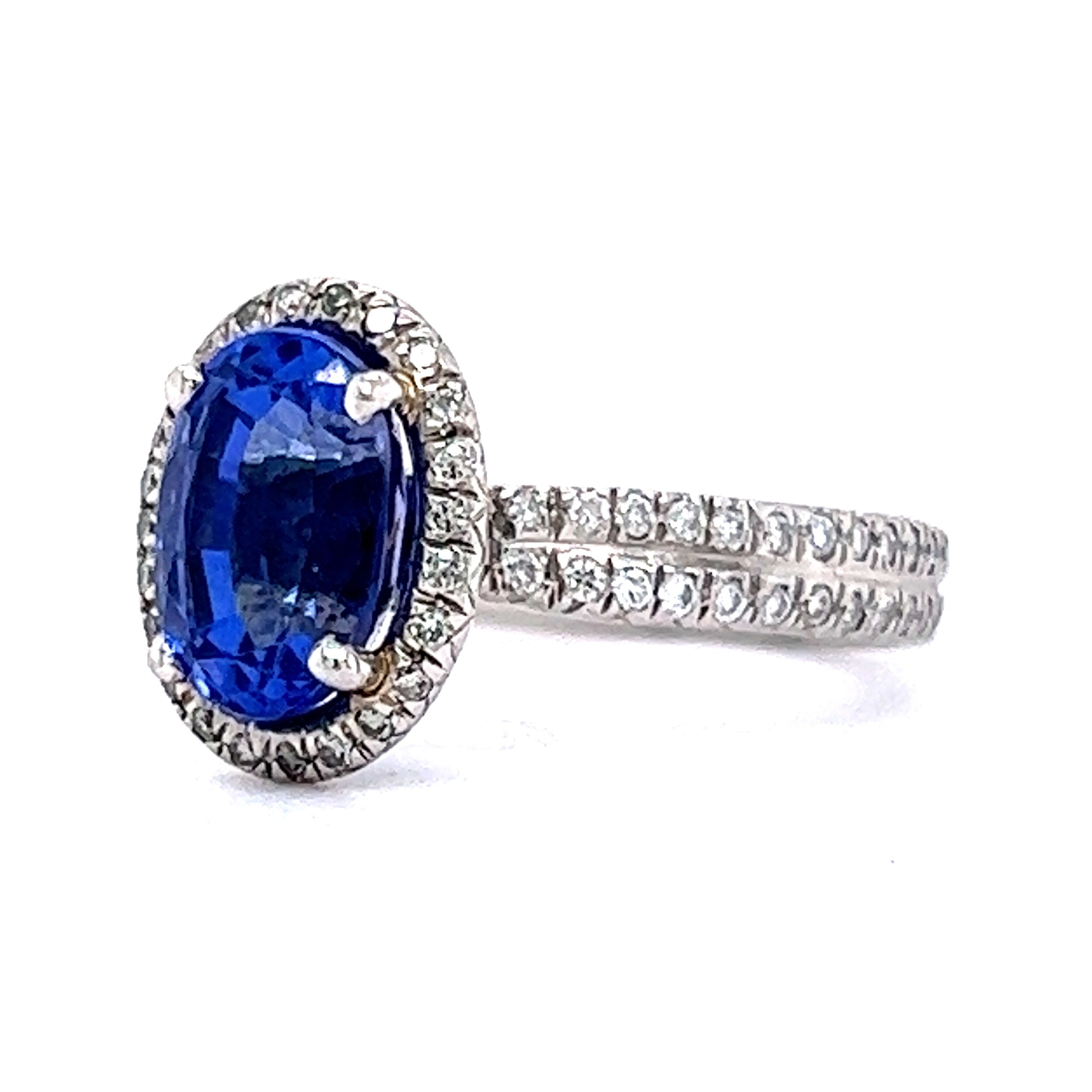 Oval Cut Tanzanite & Diamond Halo Ring in PlatinumComposition: PlatinumTotal Diamond Weight: .59 cttw ctTotal Gram Weight: 6.1 gInscription: FABRIKANT PT950