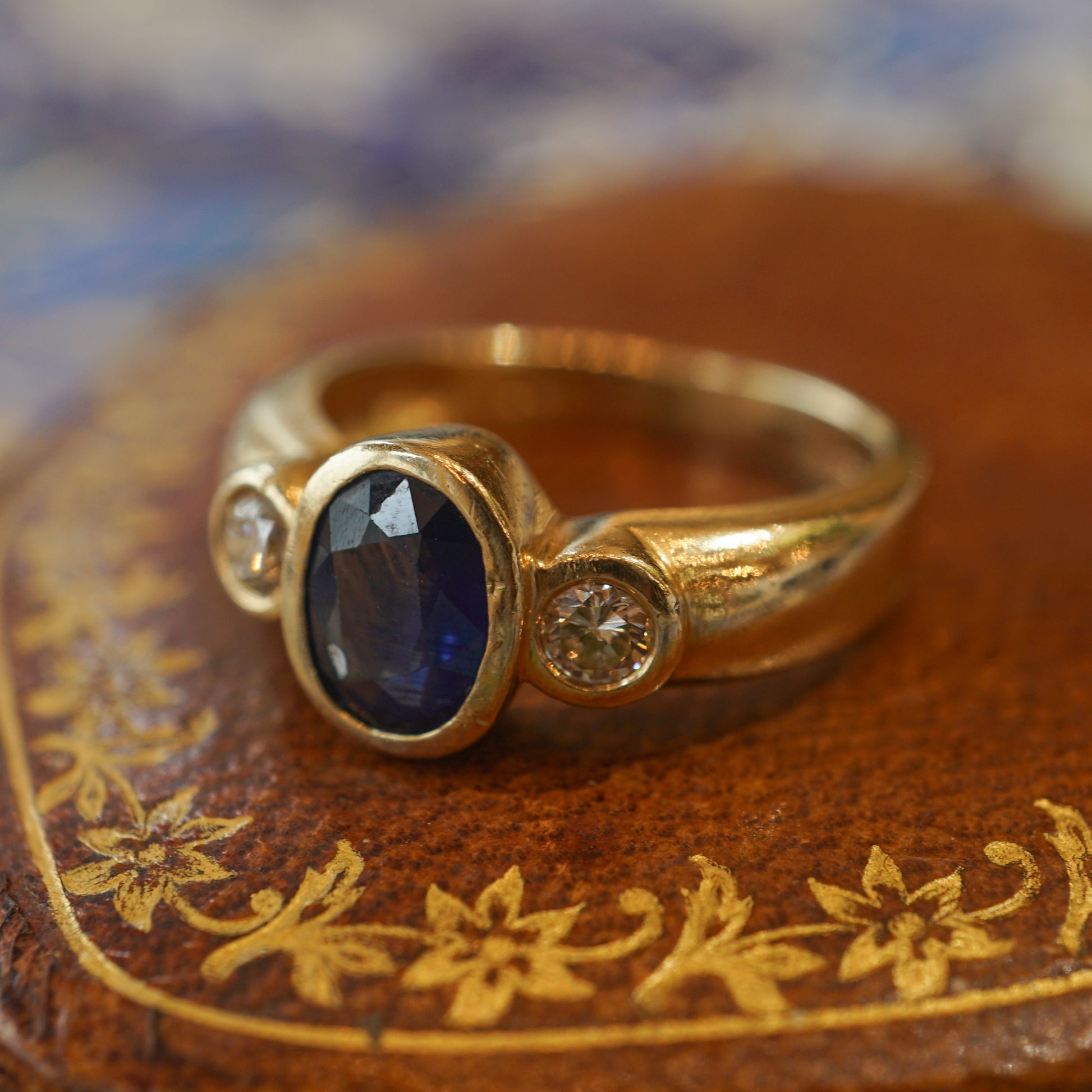 Bezel Set Oval Sapphire & Diamond Ring in 14k Yellow GoldComposition: 14 Karat Yellow GoldRing Size: 7.75Total Diamond Weight: .30 ctTotal Gram Weight: 6.0 gInscription: 14k BH