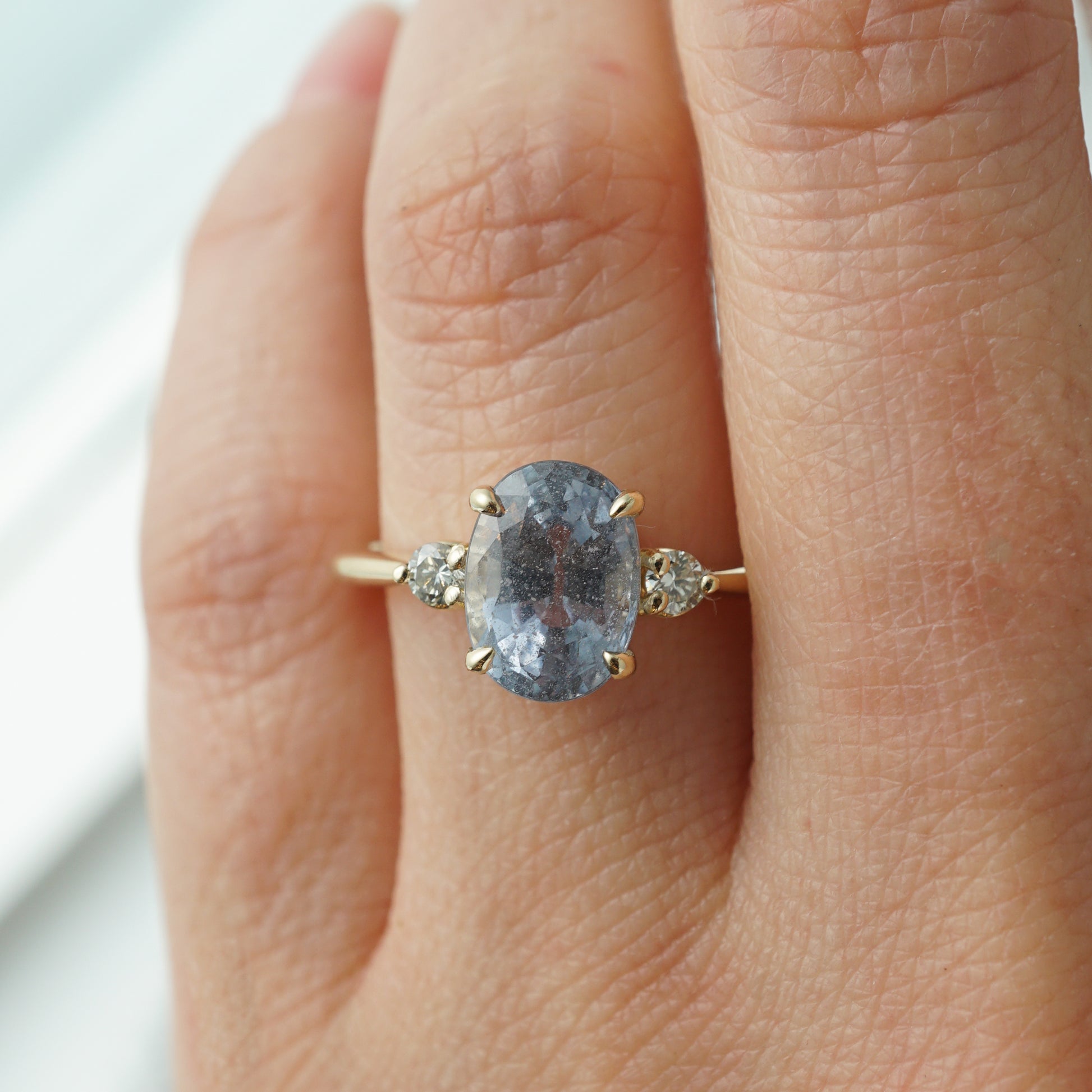 Oval Cut Lavender Sapphire Engagement Ring in Yellow GoldComposition: PlatinumRing Size: 7Total Diamond Weight: .06 ctTotal Gram Weight: 3.2 gInscription: 14k