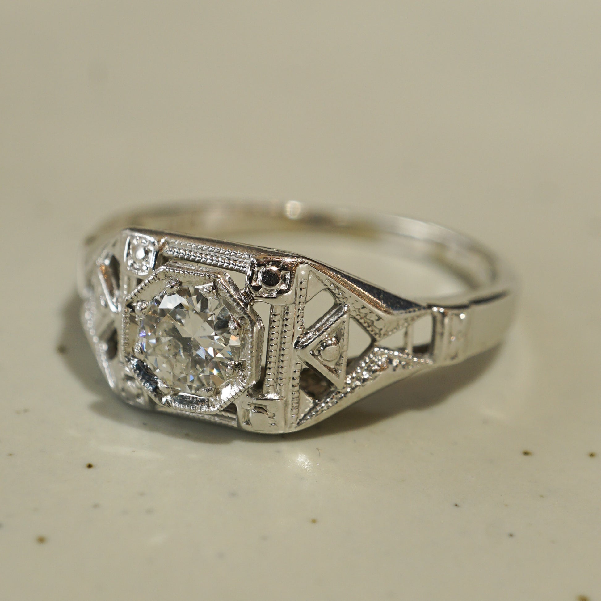 .32 Art Deco Filigree Diamond Engagement Ring in 18k White GoldComposition: 18 Karat White GoldRing Size: 5.25Total Diamond Weight: .32 ctTotal Gram Weight: 2.1 gInscription: 18KT 3025