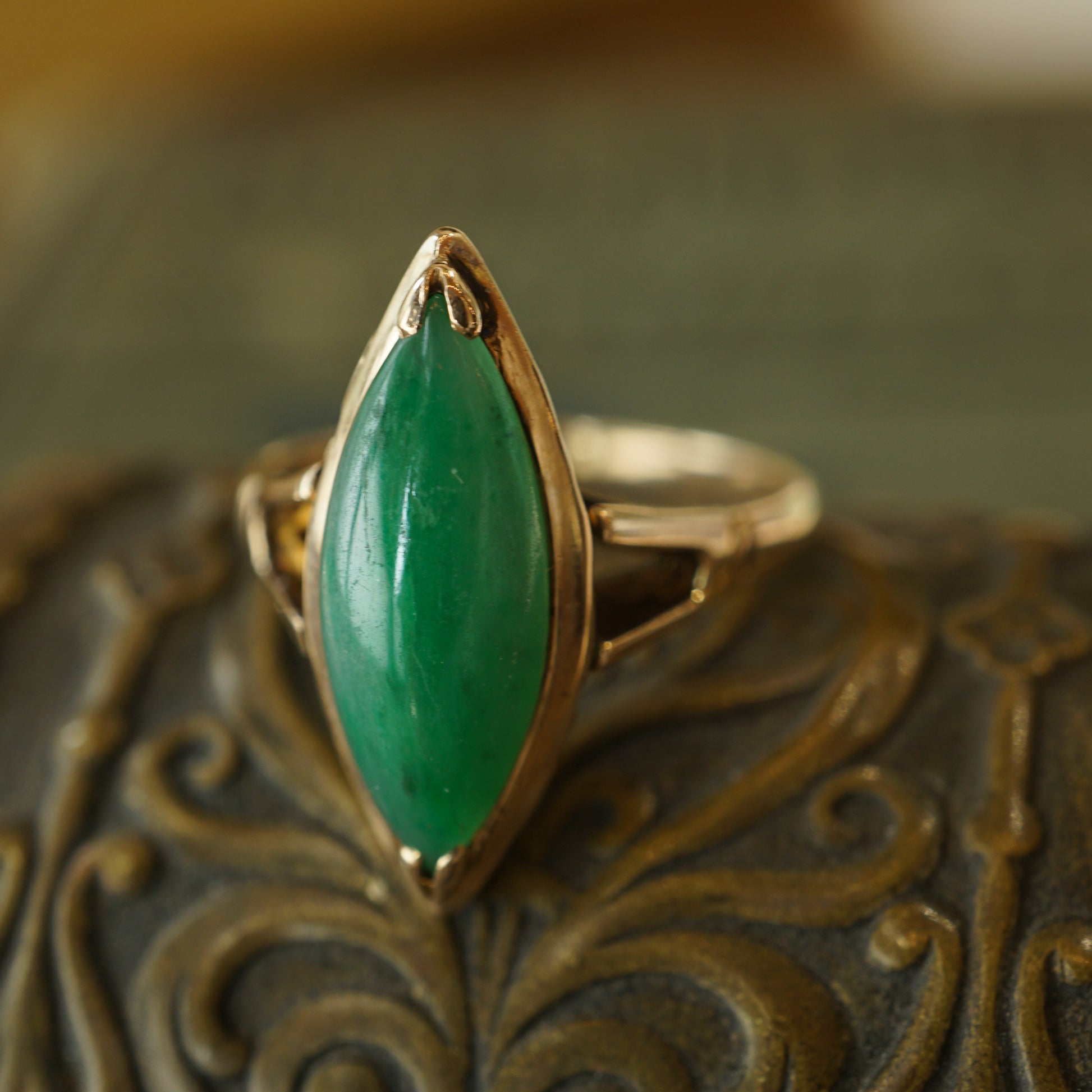 Mid-Century Marquise Shaped Jade Ring in 14k Yellow GoldComposition: 14 Karat Yellow Gold Ring Size: 7 Total Gram Weight: 3.3 g Inscription: 14k
      