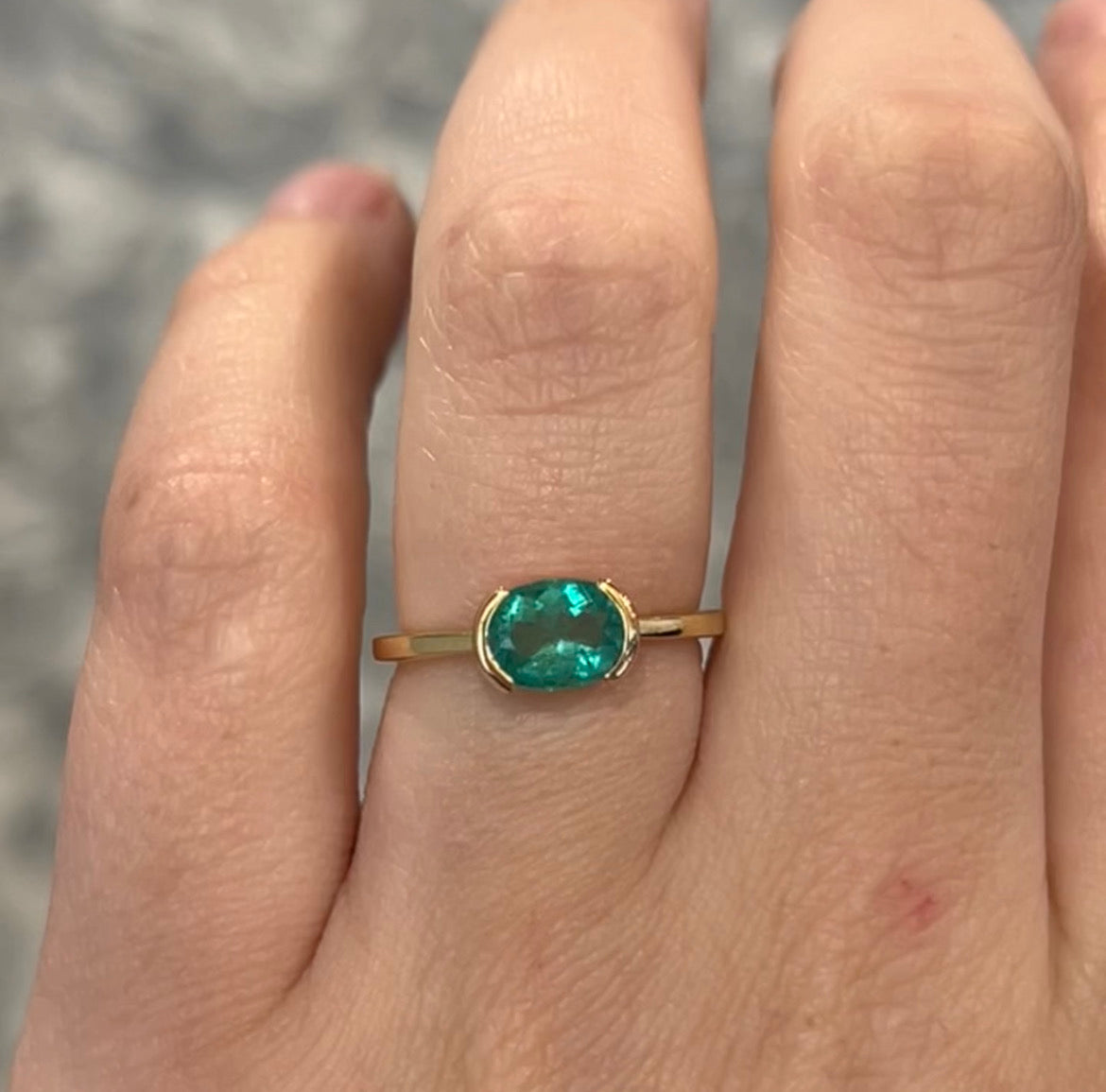 Half Bezel Set Oval Cut Emerald Ring in 14k Yellow Gold