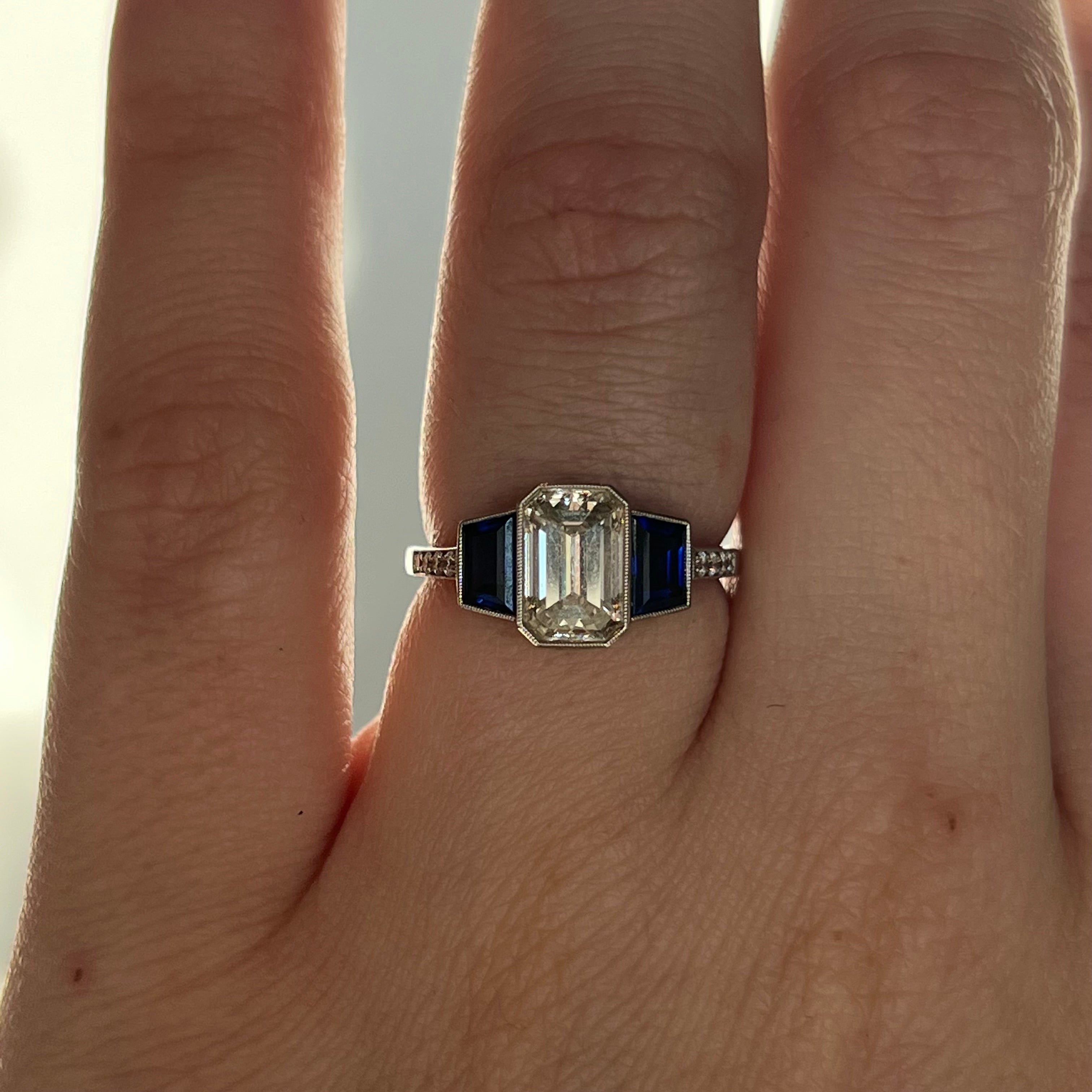 Emerald cut engagement sale rings with sapphire accents