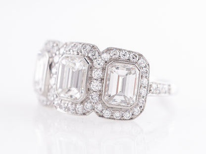 Deco Style Three Stone Emerald Cut Diamond Ring in Platinum